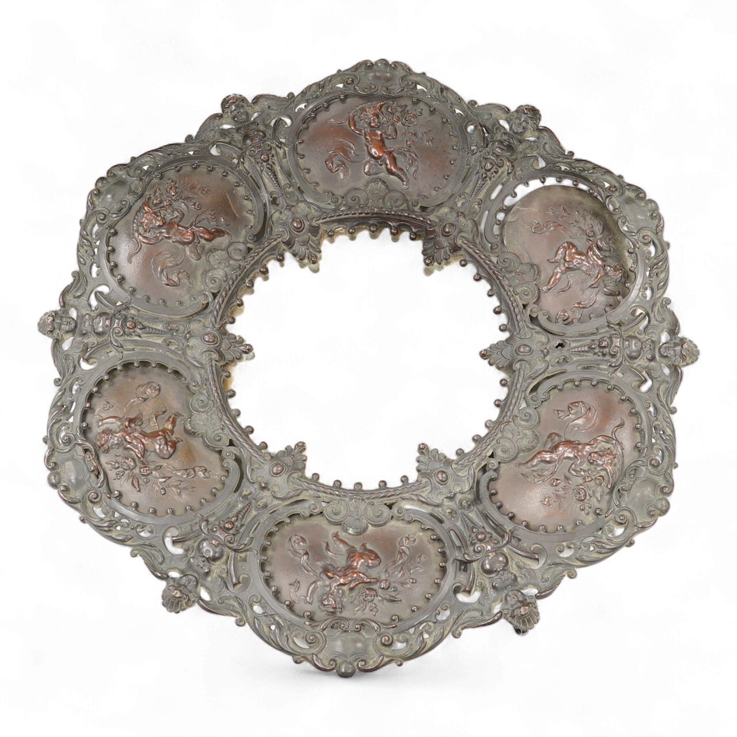 An ornate circular decorative bronzed metal putti decorated wall mirror, 40cm